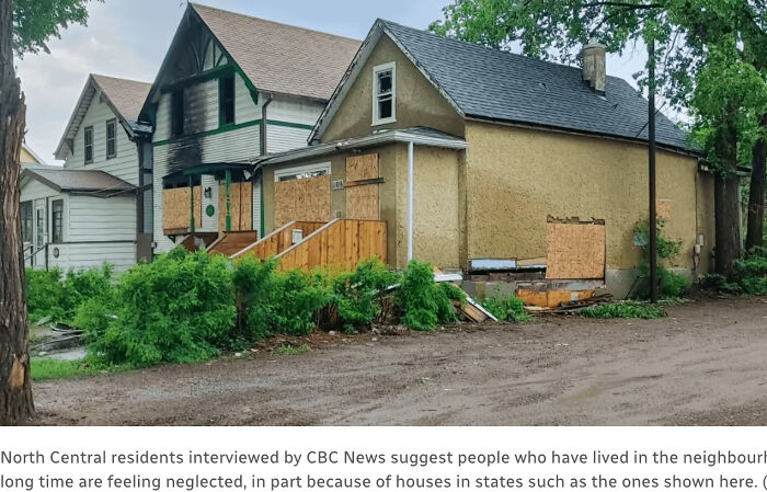 Dilapidated urban house with boarded windows, overgrown greenery, and a dirt road reflecting urban hell conditions.