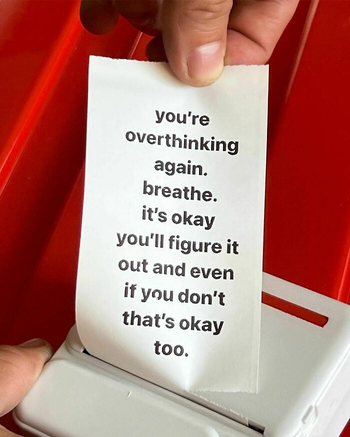 Positive message on a note about overthinking, relating to mental health.