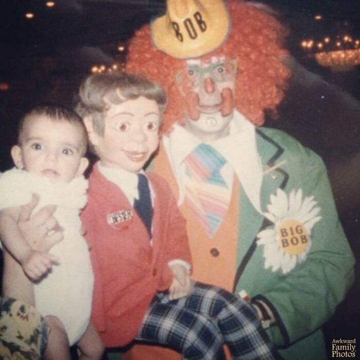 Awkward family photo with a baby, a ventriloquist dummy, and a clown named Big Bob in colorful costume.
