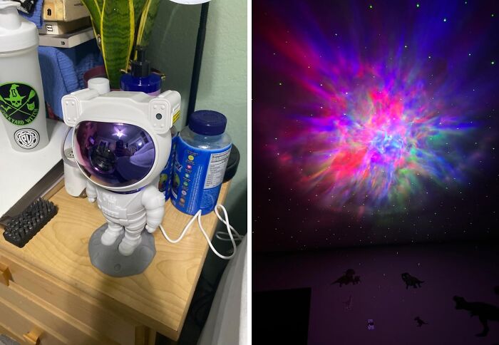 Astronaut-themed white elephant present on a nightstand with colorful galaxy light projection on ceiling.
