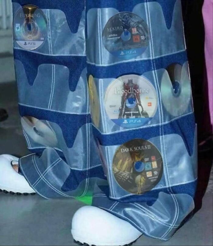 Jeans with video game discs in transparent pockets, featuring Elden Ring, Sekiro, Bloodborne, and Dark Souls III.