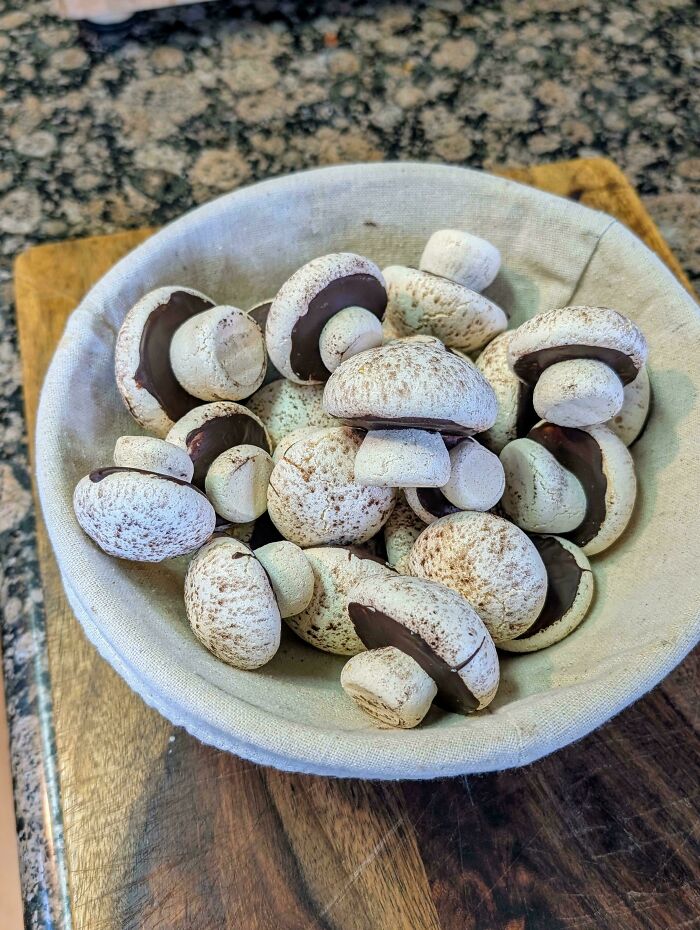 A bowl of meringue cookies shaped like mushrooms, showcasing creative baking at a whole other level.