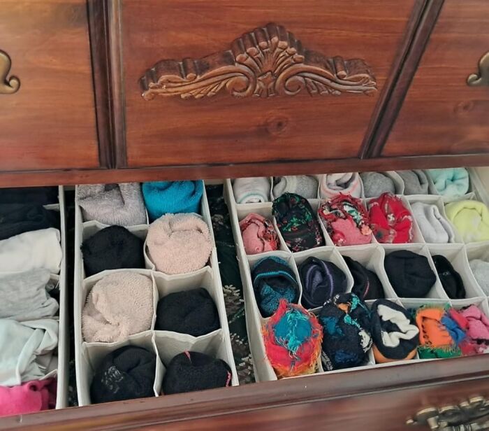 Drawer organized with dividers, featuring neatly arranged socks for effective home decluttering in 2024.