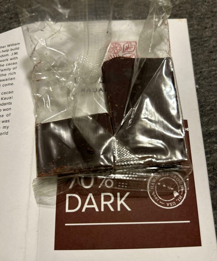 Opened chocolate bar on a table, labeled 70% dark, representing infuriating family members' common gift frustrations.