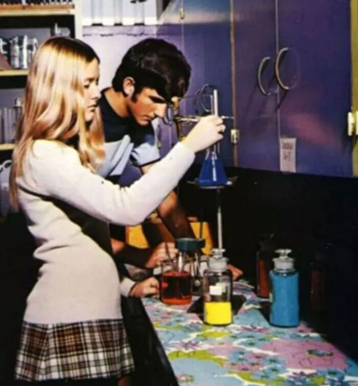 Students in a '70s high school chemistry lab working with beakers and flasks.