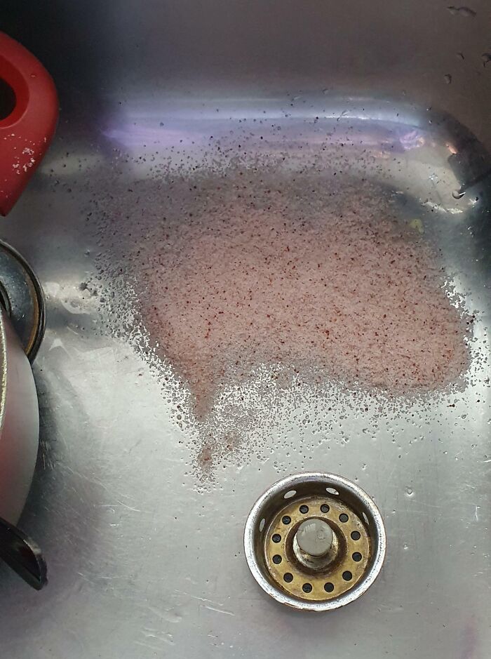 Dirty sink with leftover food and a red dish, causing frustration common with infuriating family members.