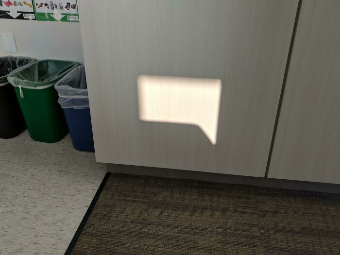Light reflection on cabinet resembles a speech bubble, reminiscent of videogame graphics.
