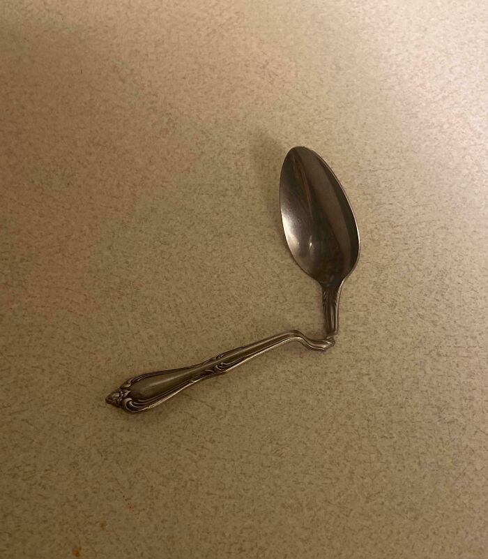 Bent spoon on a countertop, symbolizing infuriating family members' antics.