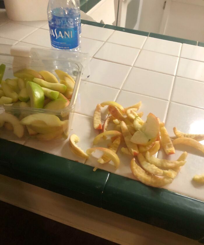 Apple cores left messily on a kitchen counter next to a container of apple slices, illustrating infuriating family members.