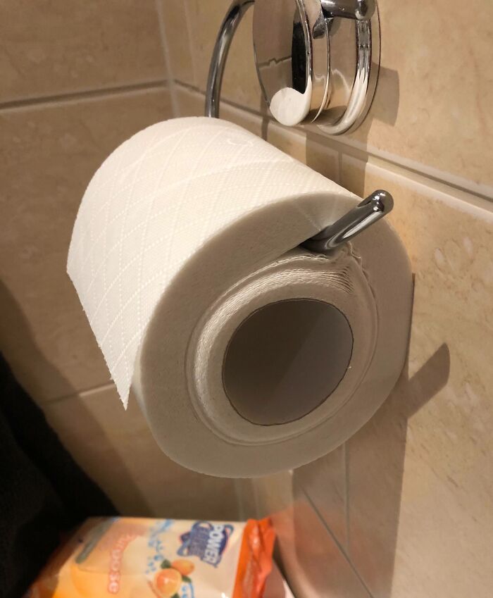 Toilet paper roll placed incorrectly, often a source of annoyance with family members.