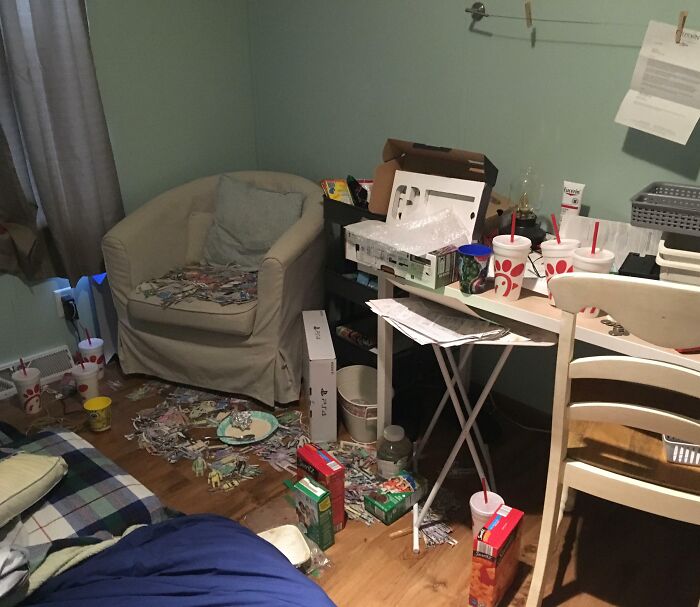 Messy room with cluttered furniture and scattered fast food containers, reflecting infuriating family member habits.