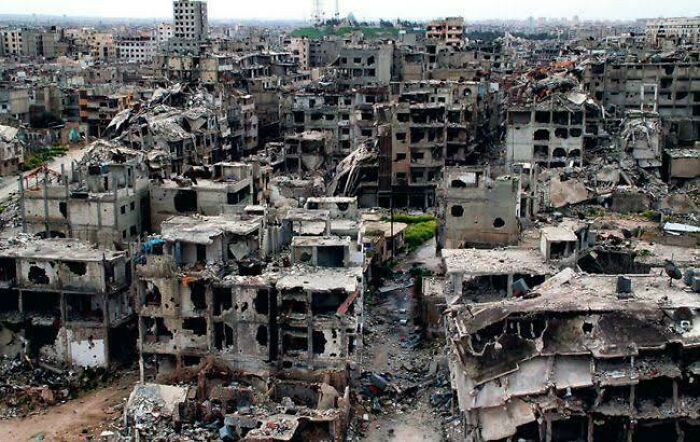 Ravaged urban landscape with collapsed buildings and debris, depicting urban hell in a cityscape setting.