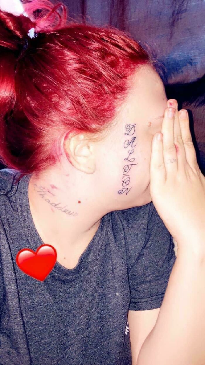 Person with face tattoo, red hair, covering face with hand, showing a questionable tattoo choice.