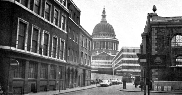 Historic city street view in 1973 with classic architecture and a prominent dome structure in the background.