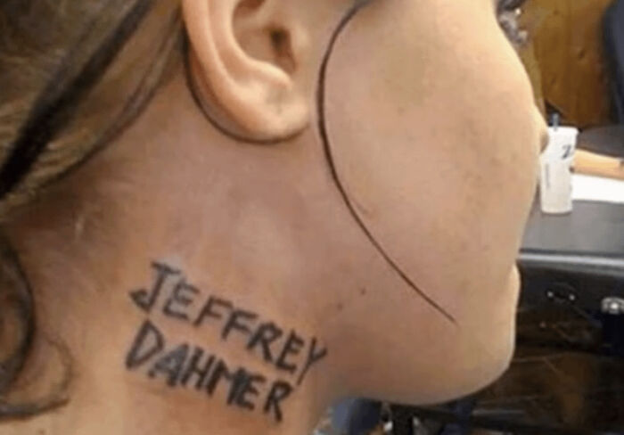 Bad tattoo featuring a controversial name inked on someone's neck.