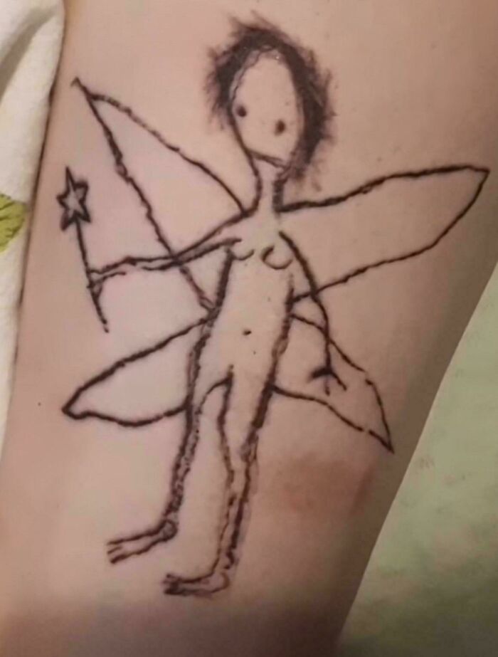 Amateur fairy tattoo with uneven lines on skin, showcasing a poorly executed tattoo design.