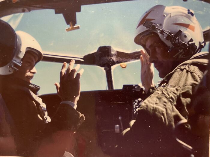 Pilots in helmets communicate inside a cockpit, 1973 world in pictures.