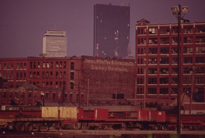 1973 urban landscape with historic buildings and industrial foreground, capturing the essence of the city's architecture.
