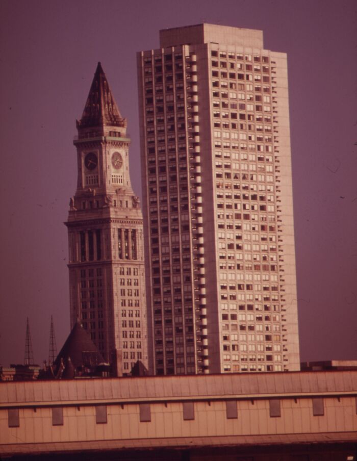 Two skyscrapers in 1973, with distinct architecture against a clear sky.