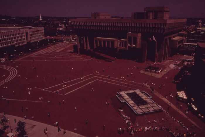 1973 city square scene with a large building and people scattered around, showcasing a historic world in pictures.