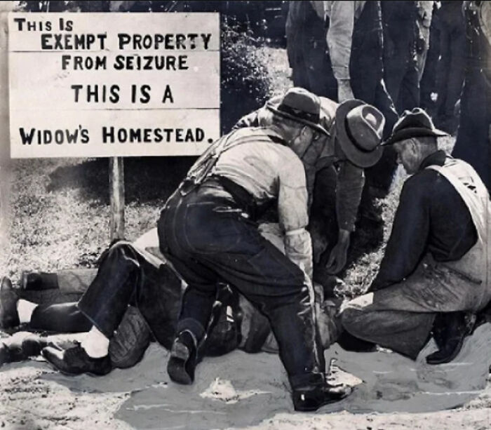 Men gather near a sign reading "Widow's Homestead," highlighting fascinating facts about property rights protection.