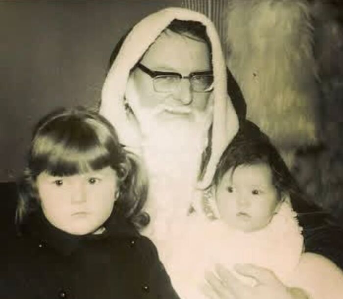 Vintage photo of Santa with two kids, featuring Creepy-Santas elements.