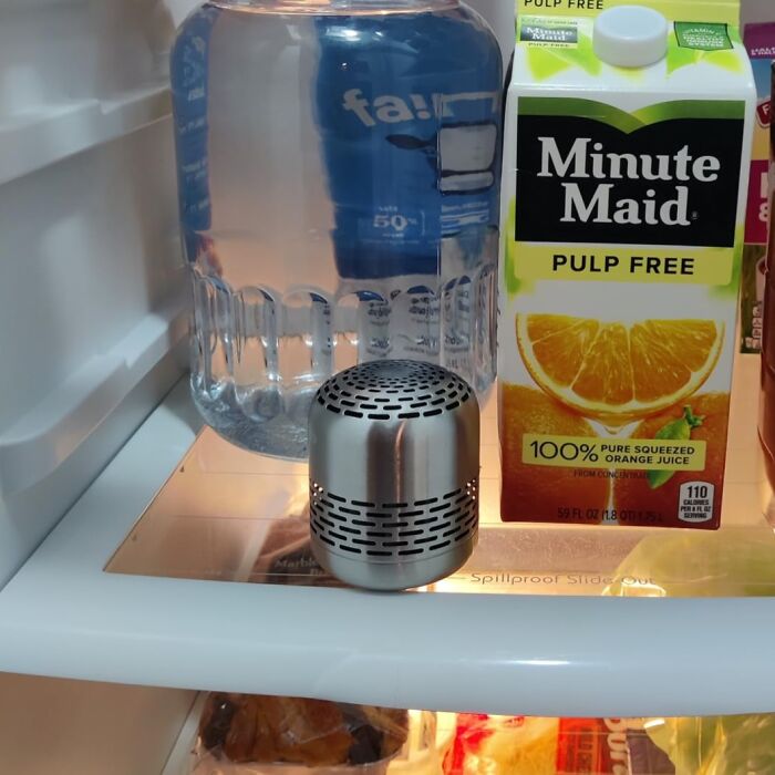 Fridge deodorizer beside water jug and orange juice, one of the best buys from Amazon this year.