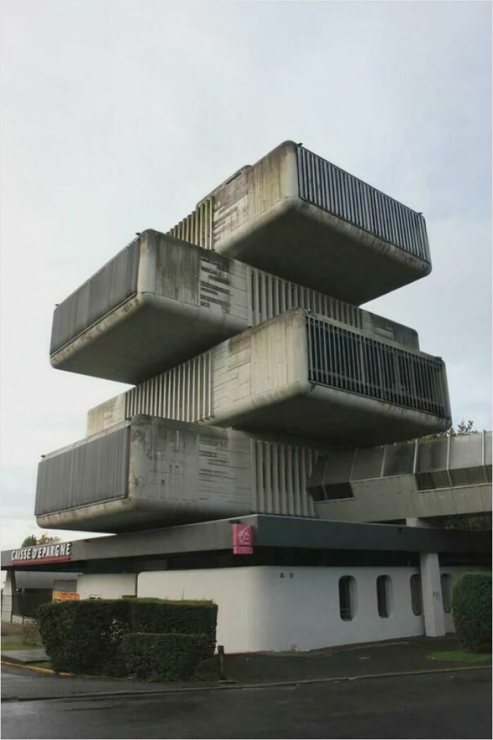 Urban hell: a brutalist concrete structure with stacked, boxy design and visible weathering.