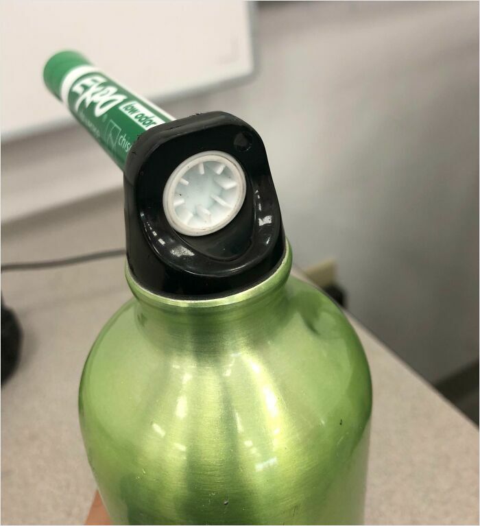 Green marker perfectly fitting into the top of a green bottle.