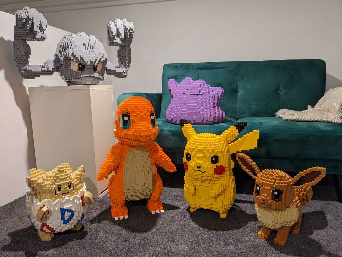 Cool LEGO builds of various Pokémon characters displayed in a cozy room with a green sofa background.