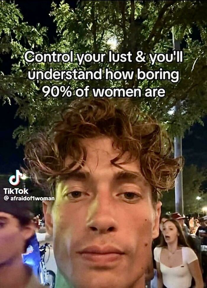 Young man with a serious expression, with text implying 90% of women are boring, outdoors at night.