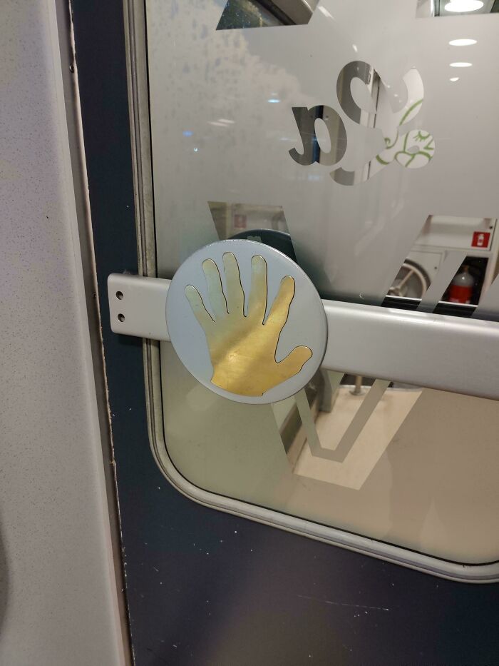 Door handle with a golden hand shape that looks confusing, illustrating a perfectly preventable fail.