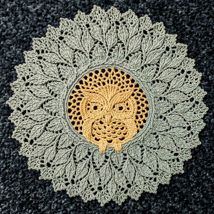 Intricate crochet project featuring a detailed owl motif surrounded by leaf patterns, showcasing proud crochet enthusiasm.