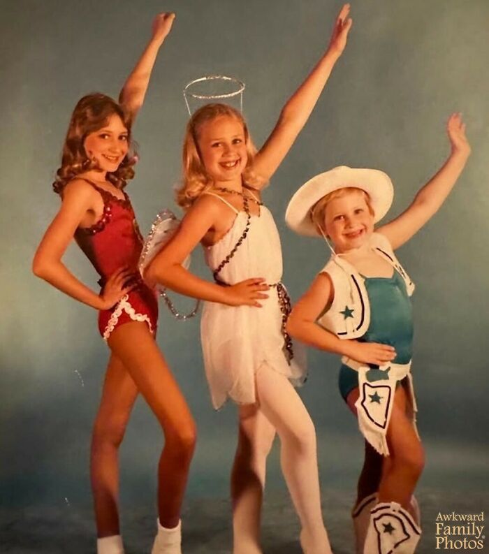 Three children in colorful costumes striking playful poses, embodying awkward family photo charm.