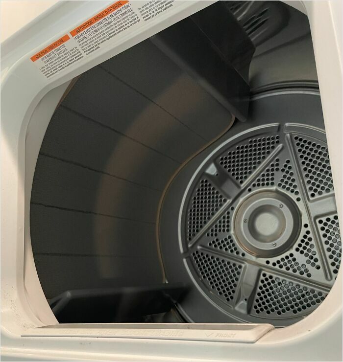 Drum of a dryer showcasing a satisfying perfect fit with its sleek, circular design.