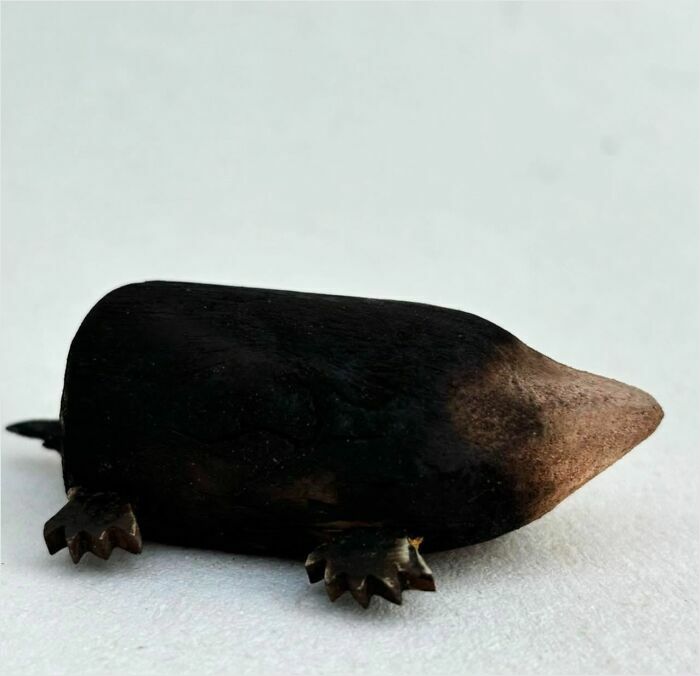 Unique driftwood animal sculpture of a small creature by Kirsty Elson, showcasing detailed craftsmanship.