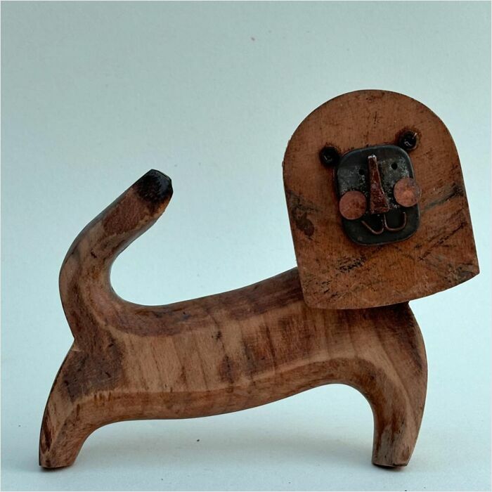 Driftwood lion sculpture by Kirsty Elson, showcasing unique animal art design.