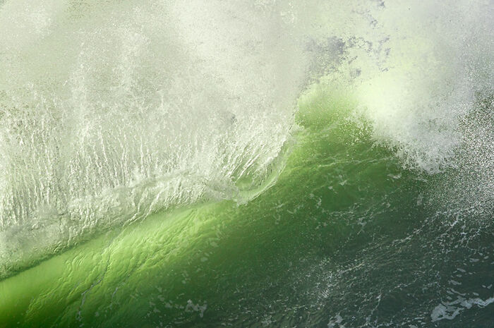 Fascinating wave photography showcasing vibrant green surf and splashing water.