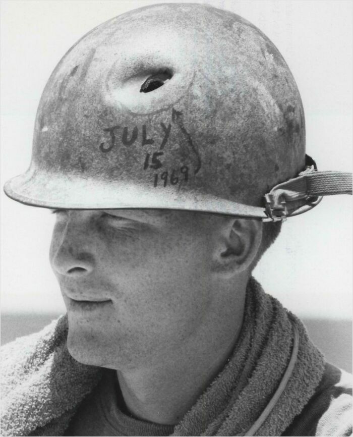 Man wearing marked construction helmet from July 15, 1969, illustrating rare historical moments.