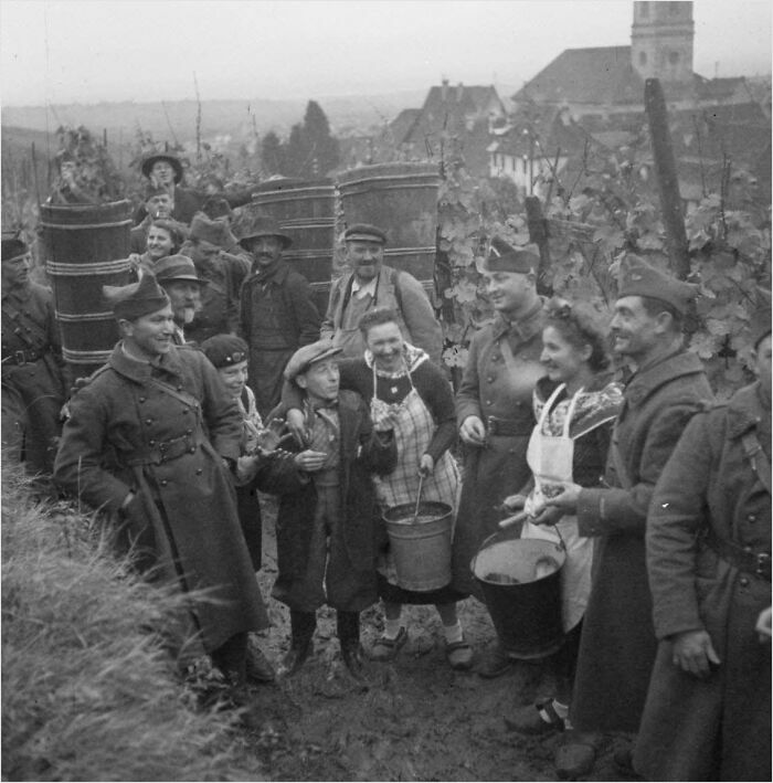 Historical group photo in a vineyard with soldiers and civilians, likely unseen in most history textbooks.