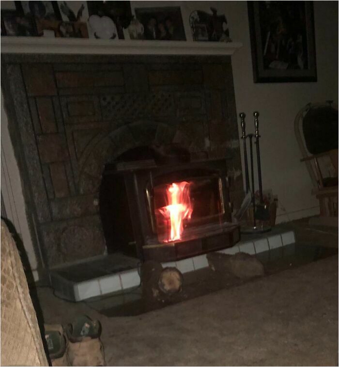 A cozy living room fireplace with glowing embers resembling a scene from a videogame.