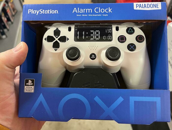 PlayStation-themed alarm clock in a retail package, resembling a gaming controller.