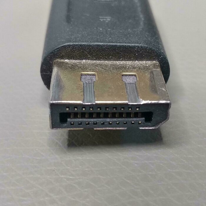 Close-up of a tech support worker’s HDMI cable connector highlighting common hardware used in the tech support profession.