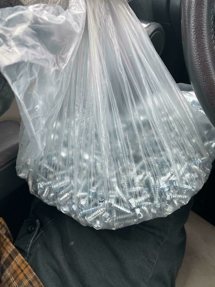 Bag filled with metal screws found while dumpster diving, showcasing unexpected treasures.