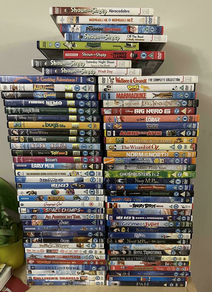 Stack of various DVDs including children's movies found while dumpster diving.