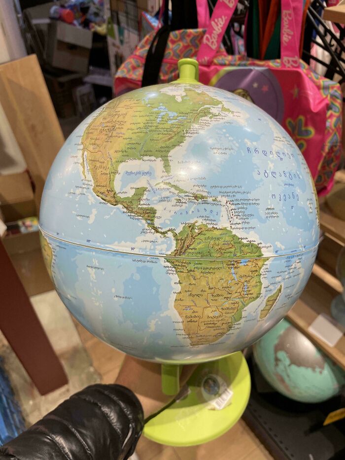 A globe on a stand with unusual geographic labels, offering mildly interesting amusement.