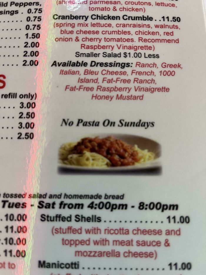Menu showing various salad options and dressings, with a sign stating "No Pasta On Sundays" for mild amusement.