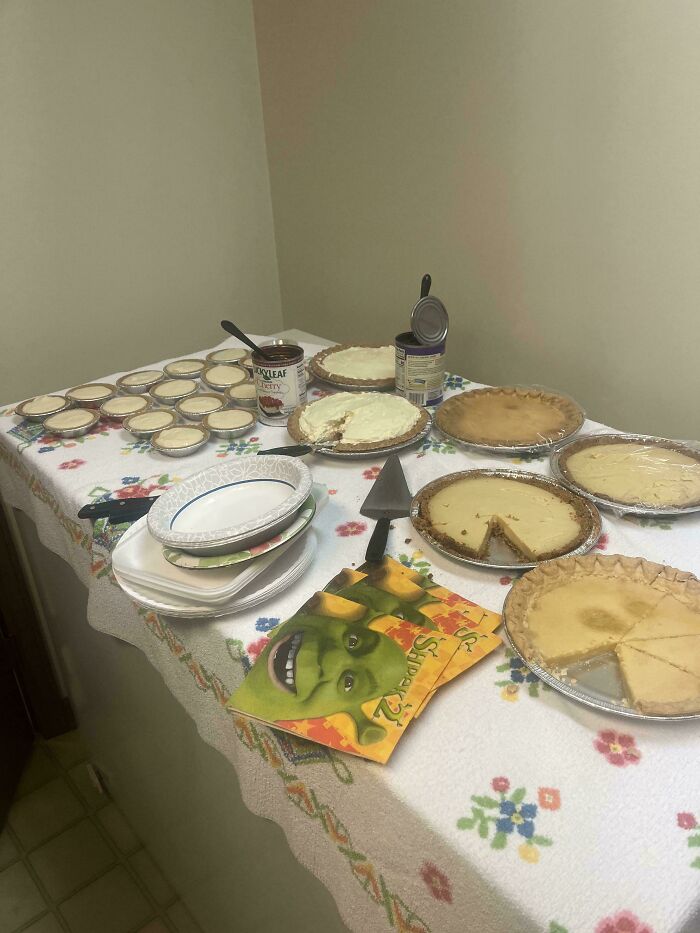 Assorted pies and canned toppings on a floral tablecloth, offering mildly interesting visual amusement.