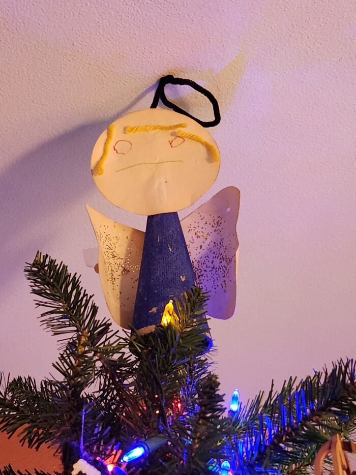 Paper angel tree topper on a decorated Christmas tree for mildly interesting amusement.