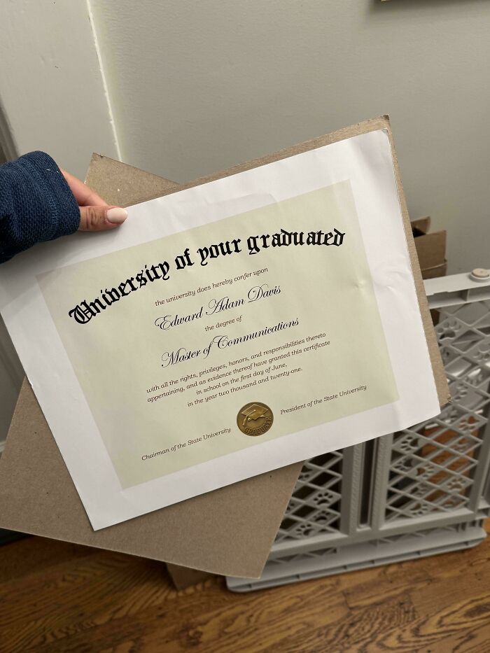 Mildly interesting diploma with unusual font style, held by a person, providing temperate amusement.